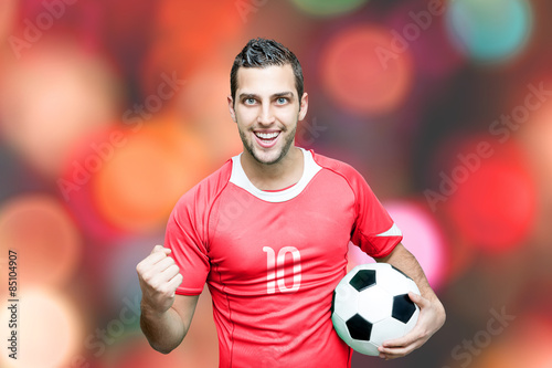 Fan with red t-shirt celebrates on bokeh background © gustavofrazao
