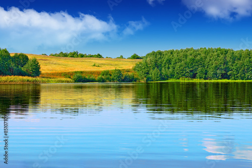 Landscape of beautiful lake and oats field