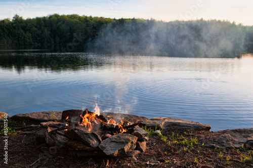 camp fire by a lake