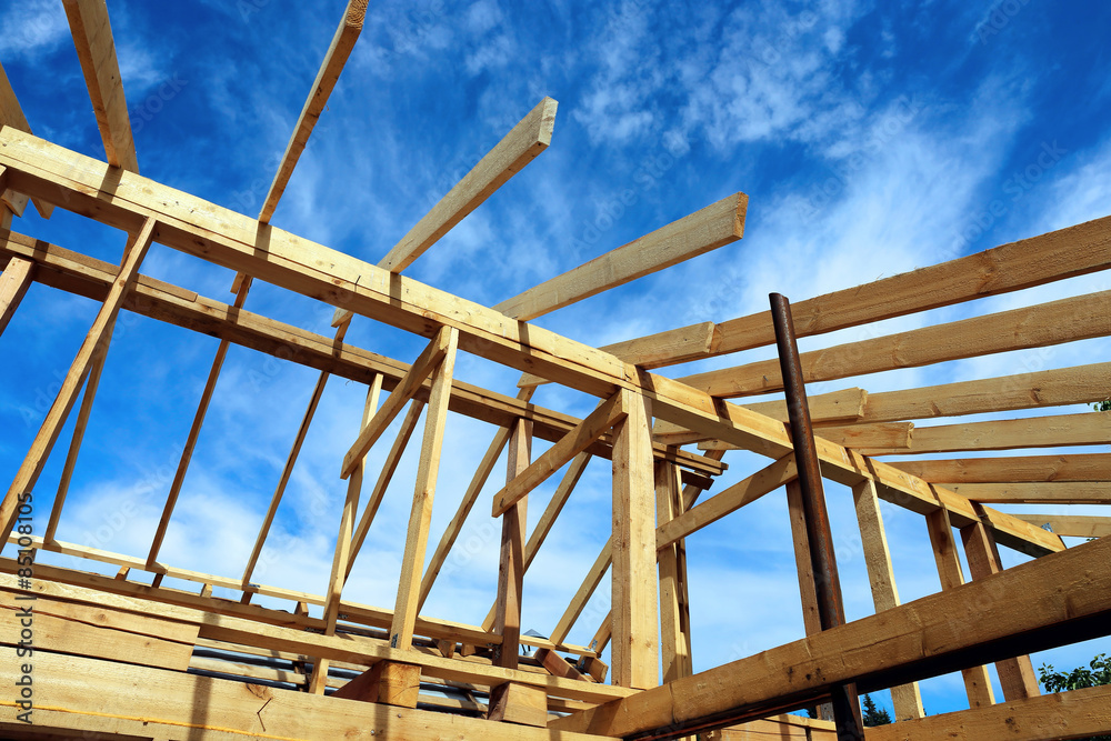 Installation of wooden beams at construction of the frame house