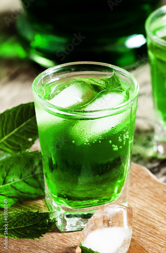 Green cocktail with mint, ice and soda, selective focus
