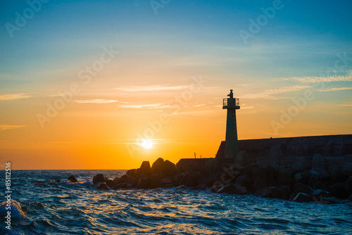 lighthouse under sunburst