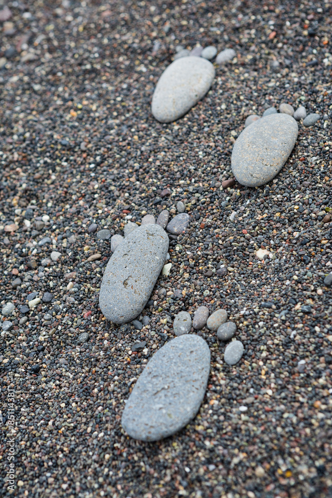 Footprint on wet sea pebbles