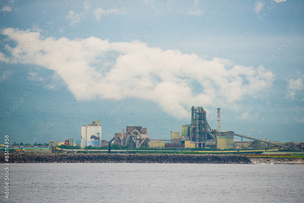 Naklejka premium Old cement factory close to the sea