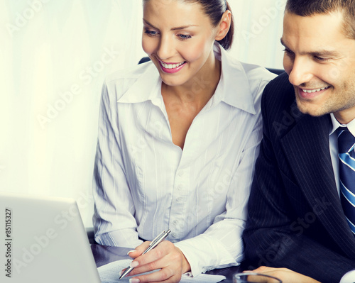 Portrait of happy young businesspeople working at workplace photo