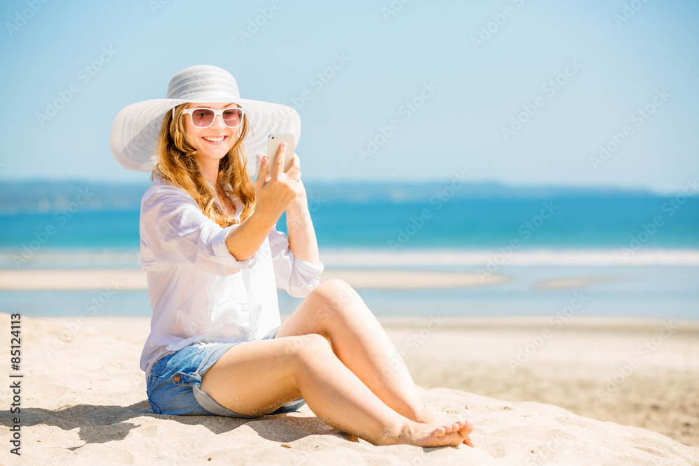 Beautifil young woman sitting on the beach at sunny day with Beautifil young woman sitting on the beach at sunny day with