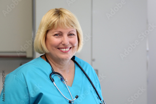 Mature Female Healthcare Professional with big smile, copy space right
