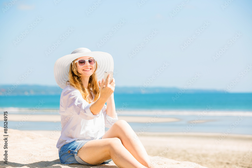 Beautifil young woman sitting on the beach at sunny day with Beautifil young woman sitting on the beach at sunny day with
