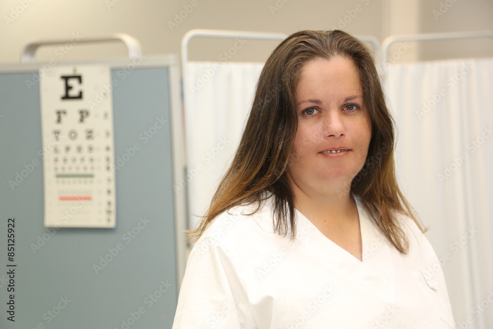 Female Healthcare Professional in Examination Room Female Healthcare Professional in Examination Room