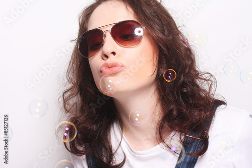 Young surprised woman wearing sunglasses.