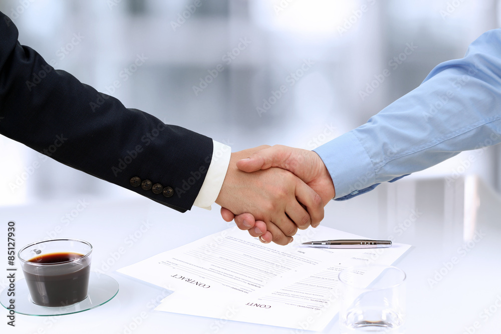 Close-up image of a firm handshake between two colleagues in of Close-up image of a firm handshake between two colleagues in of
