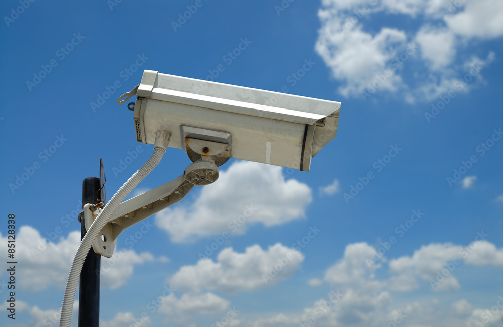 Surveillance Camera on blue sky Surveillance Camera on blue sky