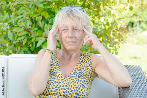 a middle-aged woman with a headache