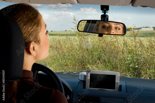 Looking at the rear-view mirror. photo
