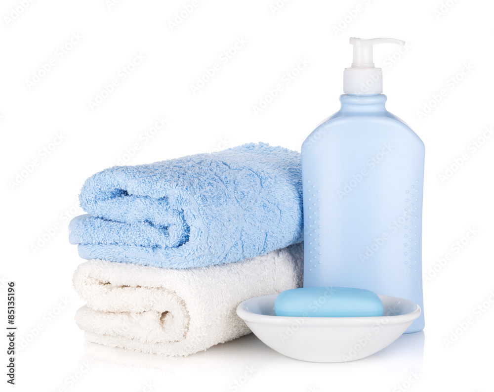 Shampoo bottle and soap with towels Shampoo bottle and soap with towels