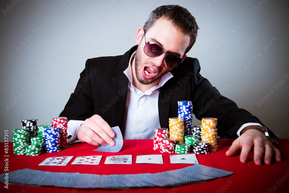 professional poker player sitting at a poker table professional poker player sitting at a poker table