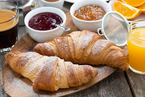 Fototapet delicious breakfast with fresh croissants on wooden table