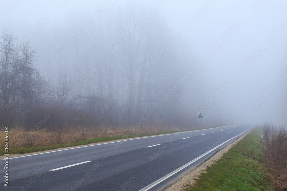 Mountain road in winter, on a overcast, foggy, day