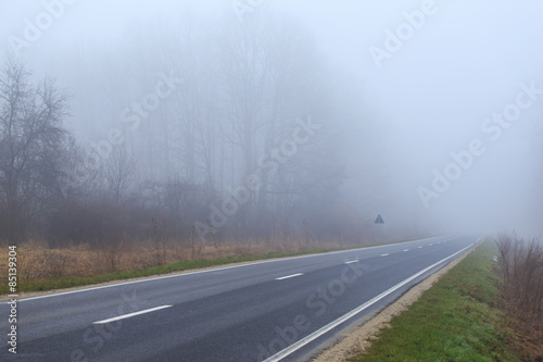 Mountain road in winter, on a overcast, foggy, day