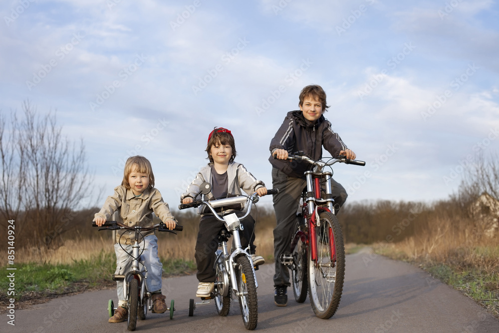 three brothers ride bikes