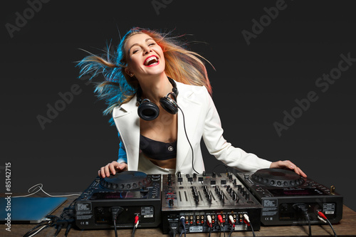 Фотография Beautiful blonde DJ girl on decks - the party,
