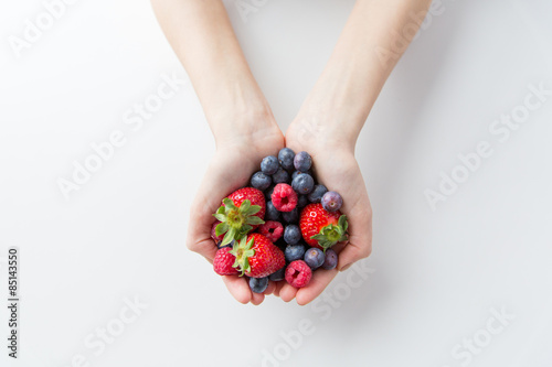 close up of woman hands holding berries photo