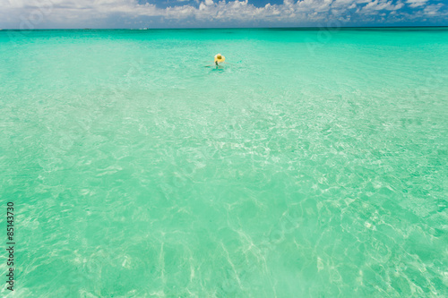 Tourist swimming in clear waters of Bahamas