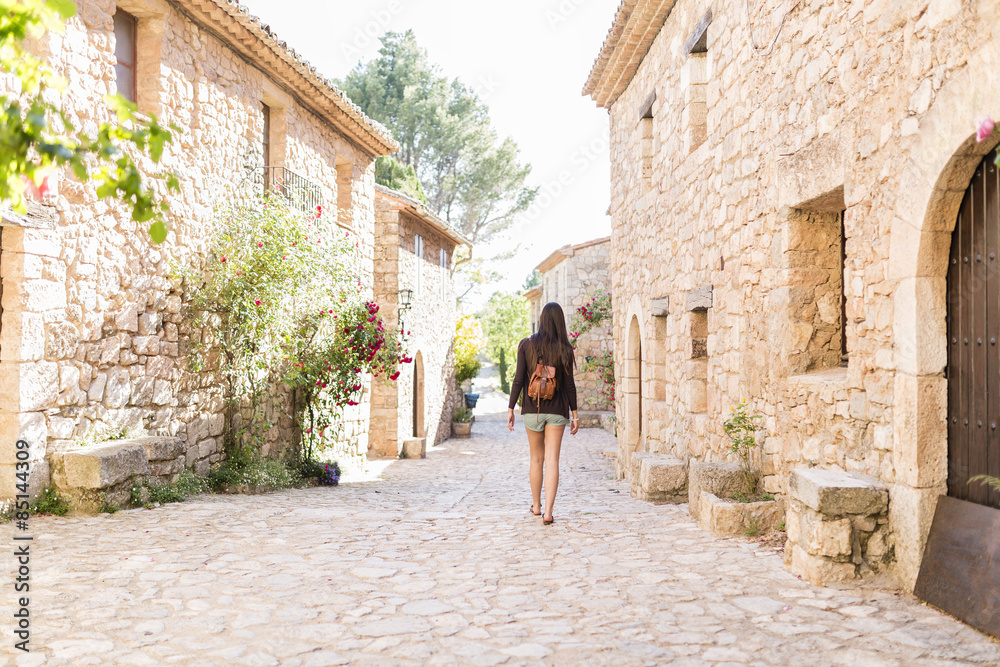 young attractive woman walking in a beautiful old town