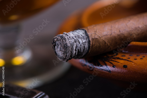 close view on cuban cigar with ash