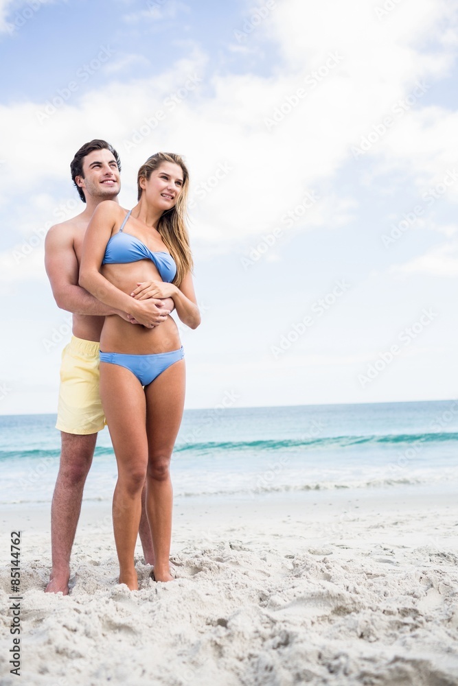 Happy couple in swimsuit embracing