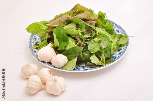 Vietnamese Basket of Herbs on a white background