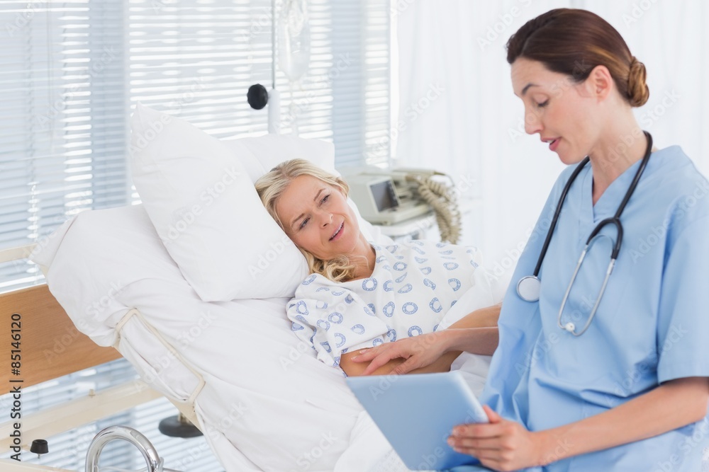 Doctor showing tablet to her patient Doctor showing tablet to her patient