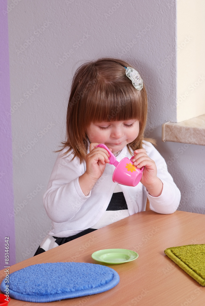 Two-year girl playing and learning in preschool Two-year girl playing and learning in preschool