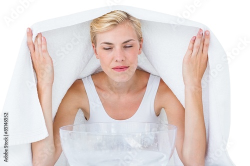 Blonde woman inhaling herbal medicine 