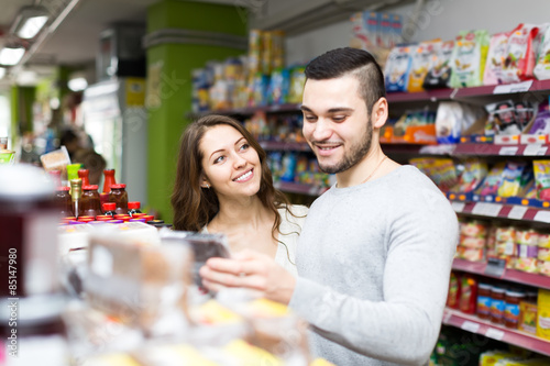 Happy woman buying food with boyfriend