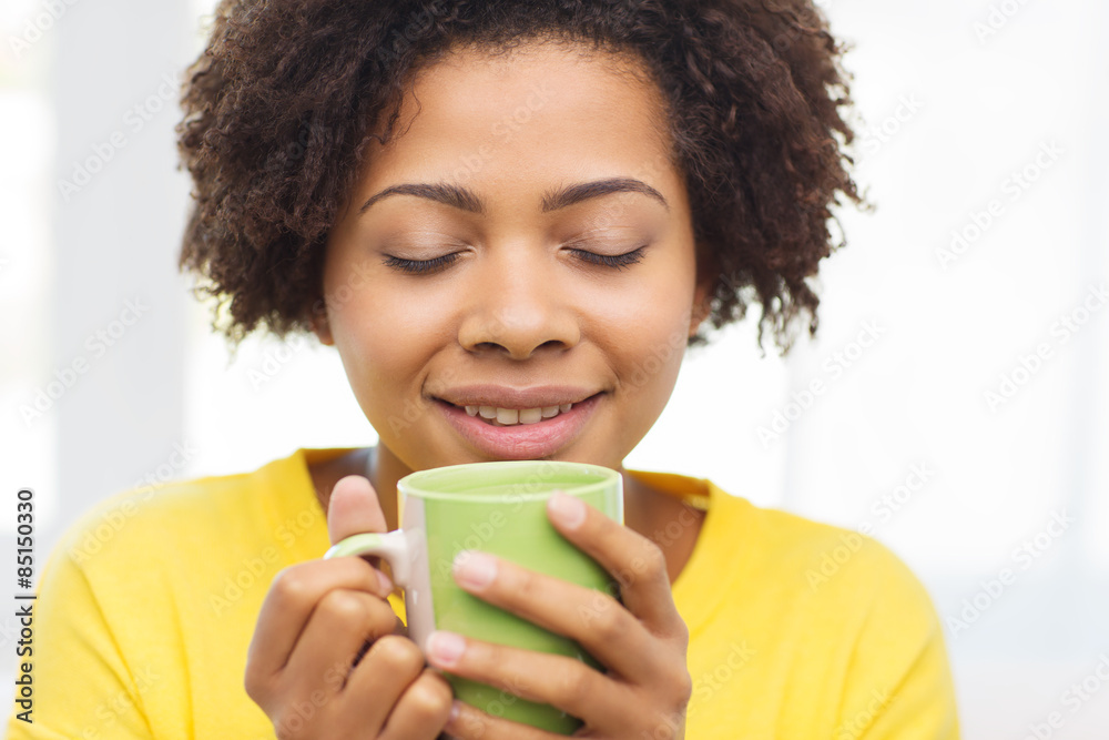 happy african american woman drinking from tea cup happy african american woman drinking from tea cup