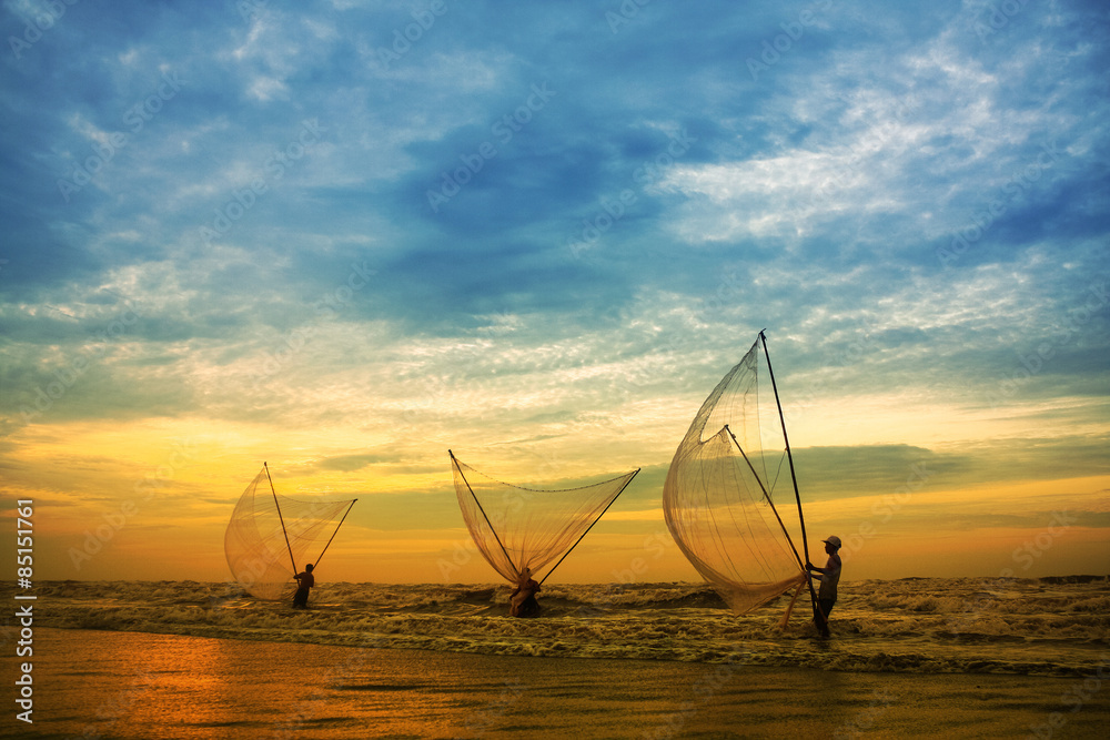 Fishermen fishing in the sea at sunrise in Namdinh, Vietnam.