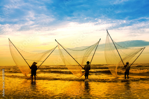 Fishermen fishing in the sea at sunrise in Namdinh, Vietnam.