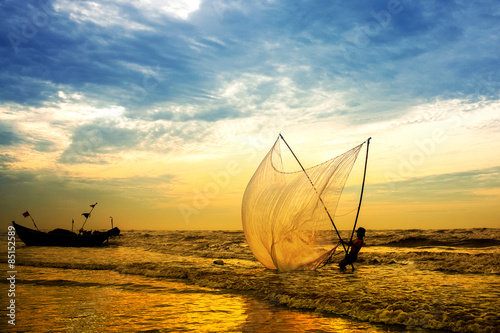 Fishermen fishing in the sea at sunrise in Namdinh, Vietnam. © cristaltran
