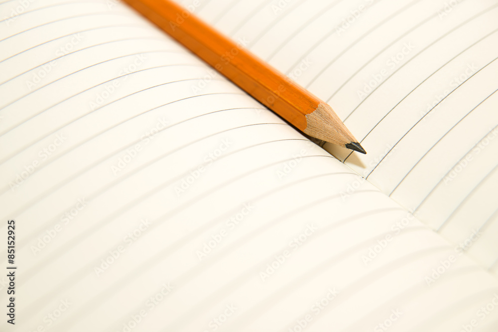 Opened notebook and pencil on the old tissue Opened notebook and pencil on the old tissue