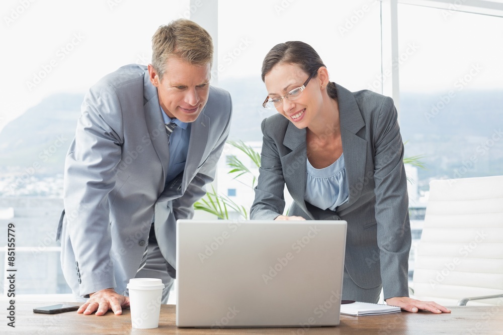 Smiling business partners working together Smiling business partners working together
