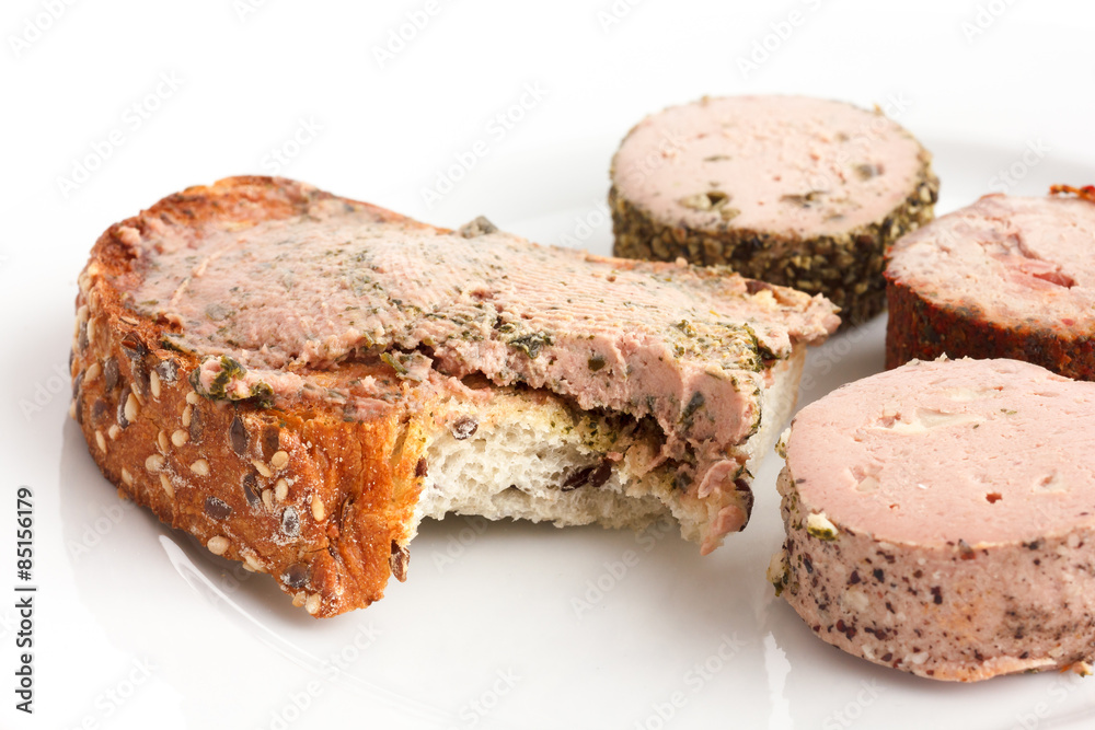 Whole grain toast spread with pate, bite missing. Whole grain toast spread with pate, bite missing.