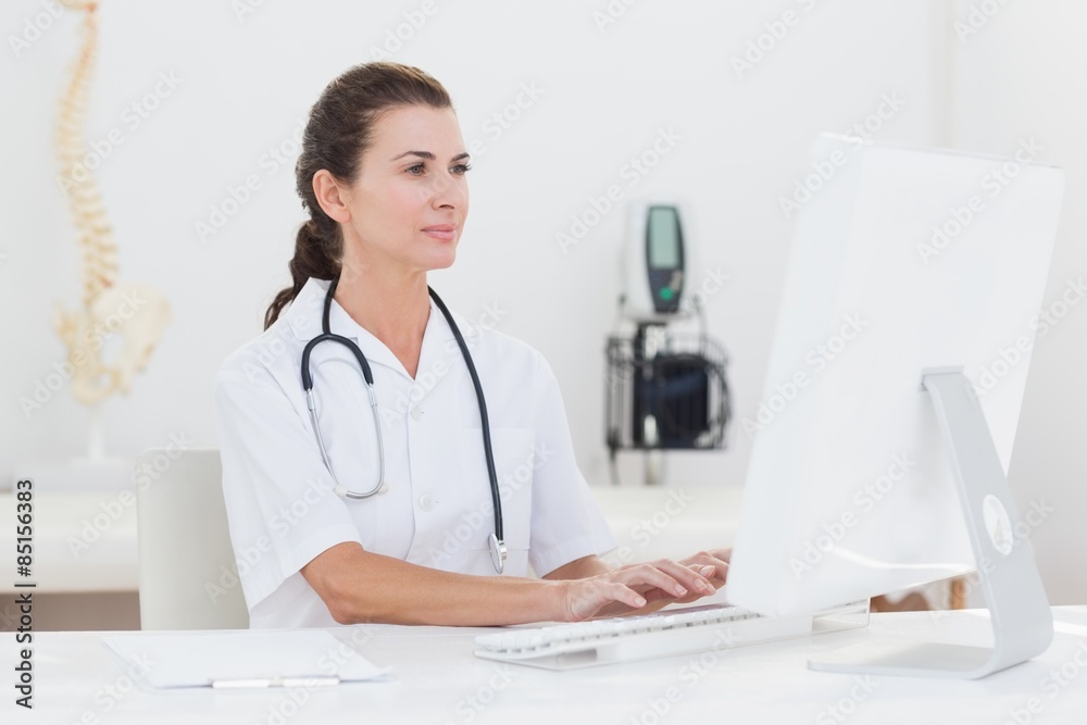 Concentrated female doctor using computer Concentrated female doctor using computer