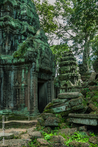 a temple or prasat of laterite with bas-reliefs in ruins in the archaeological ta prohm place in siam reap  cambodia