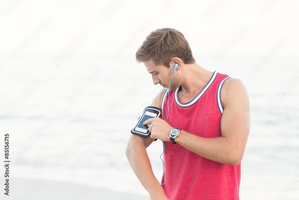 Handsome runner using his phone Handsome runner using his phone