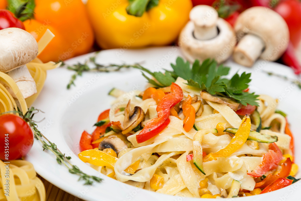 hot pasta with garnish on plate