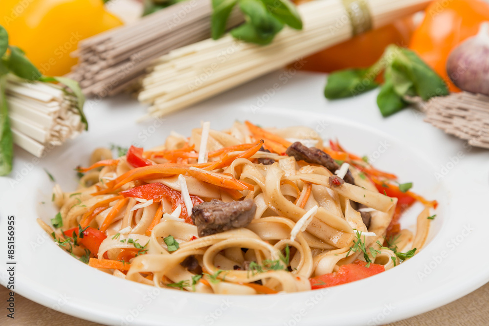 noodles with vegetables and garnish on white plate noodles with vegetables and garnish on white plate
