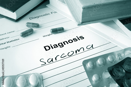 Diagnostic form with diagnosis sarcoma and pills. photo