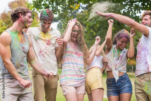 Happy friends throwing powder paint