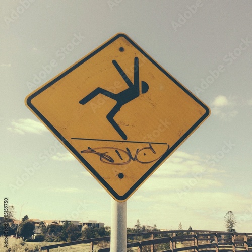 warning sign showing person falling over photo